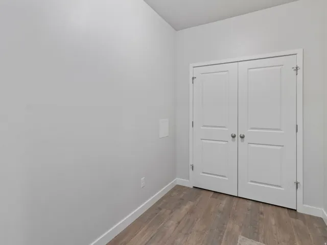 Wood-finish flooring with white baseboards