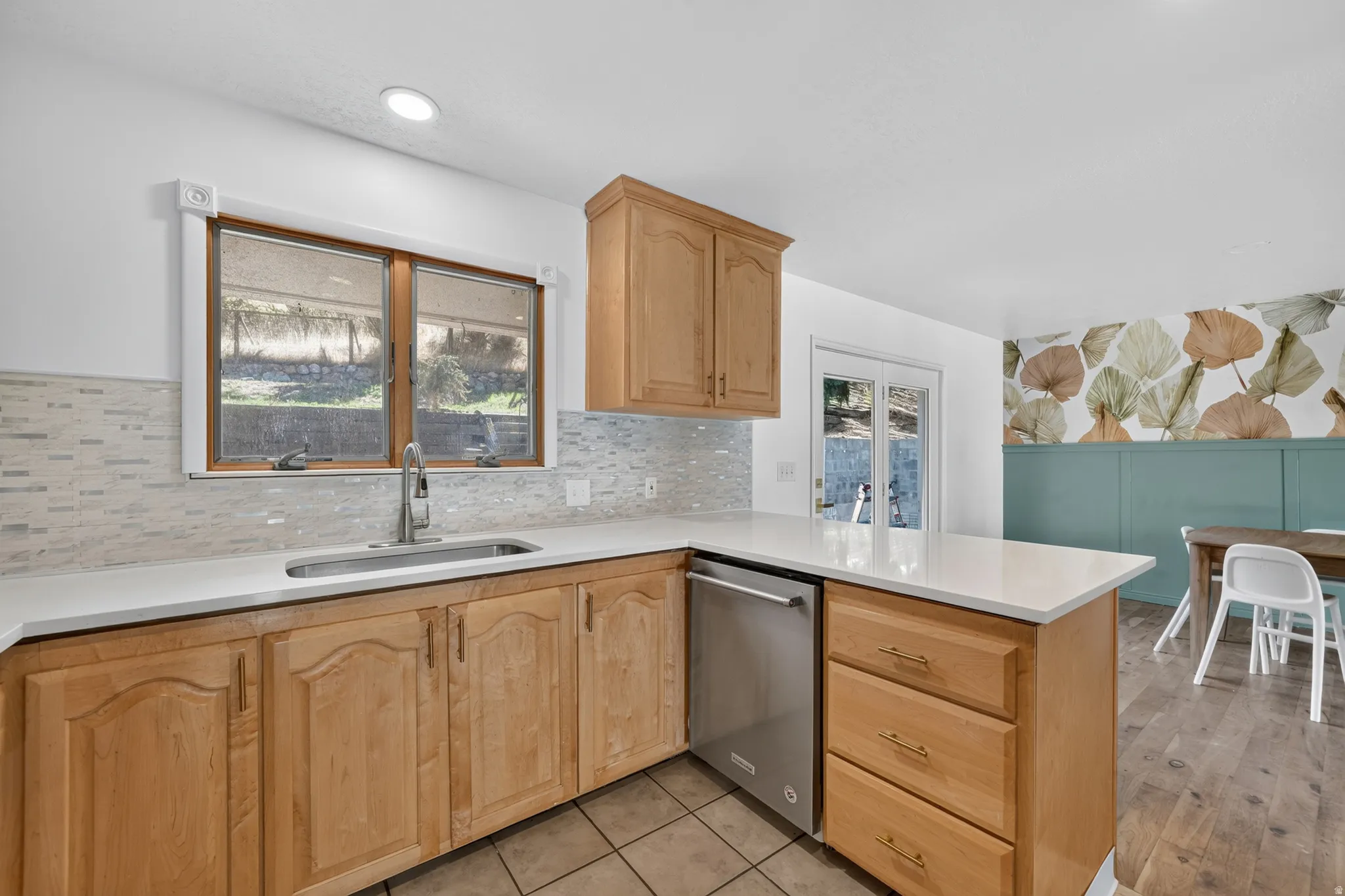 Kitchen featuring new paint, new backsplash, new quartz countertops and a new microwave. *Refrigerator, Stove, Microwave, Dishwasher all included.