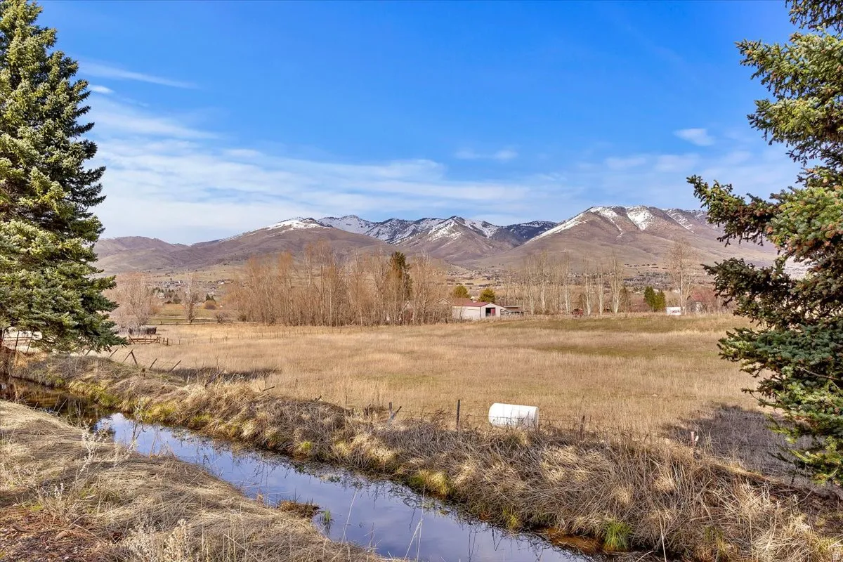 Expansive natural landscape featuring a waterway and distant mountains