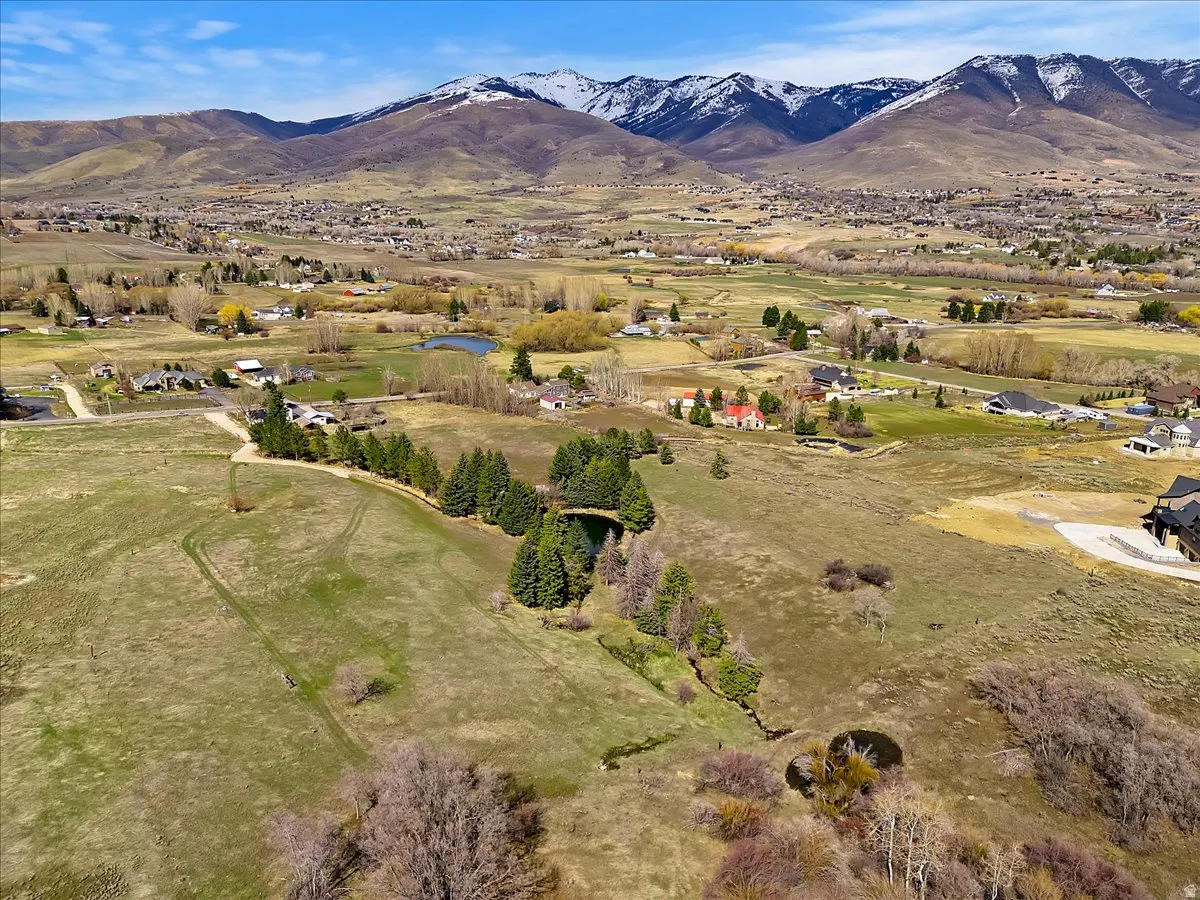 Expansive undeveloped land featuring natural terrain and distant snow-capped mountains