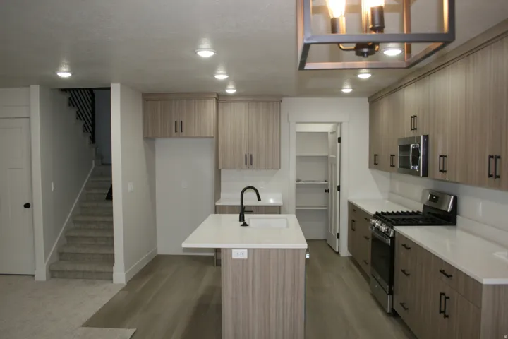 Modern kitchen featuring wood-finish cabinetry and stainless steel appliances