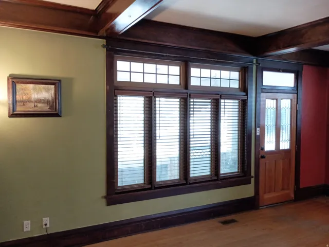 Wood-finish flooring, wood-framed windows with louvered blinds, and a wood-paneled ceiling