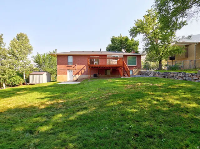 Red brick exterior with a wood deck and staircase