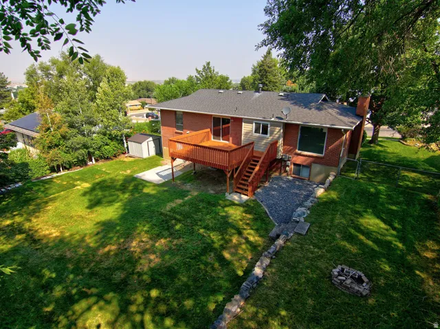 Brick exterior with a wood deck and staircase