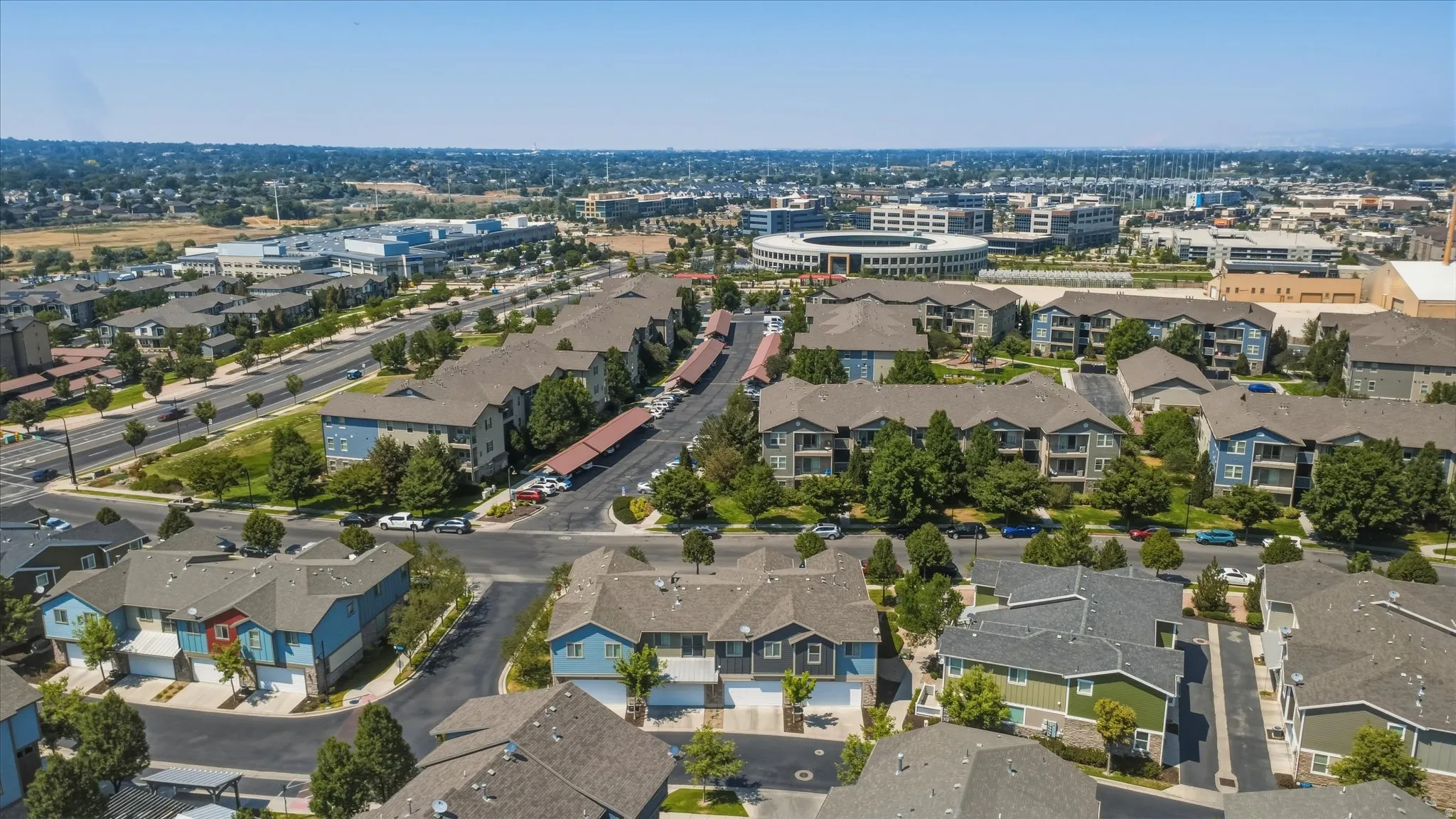 Aerial perspective showcasing varied residential structures, established landscaping, and surrounding urban infrastructure