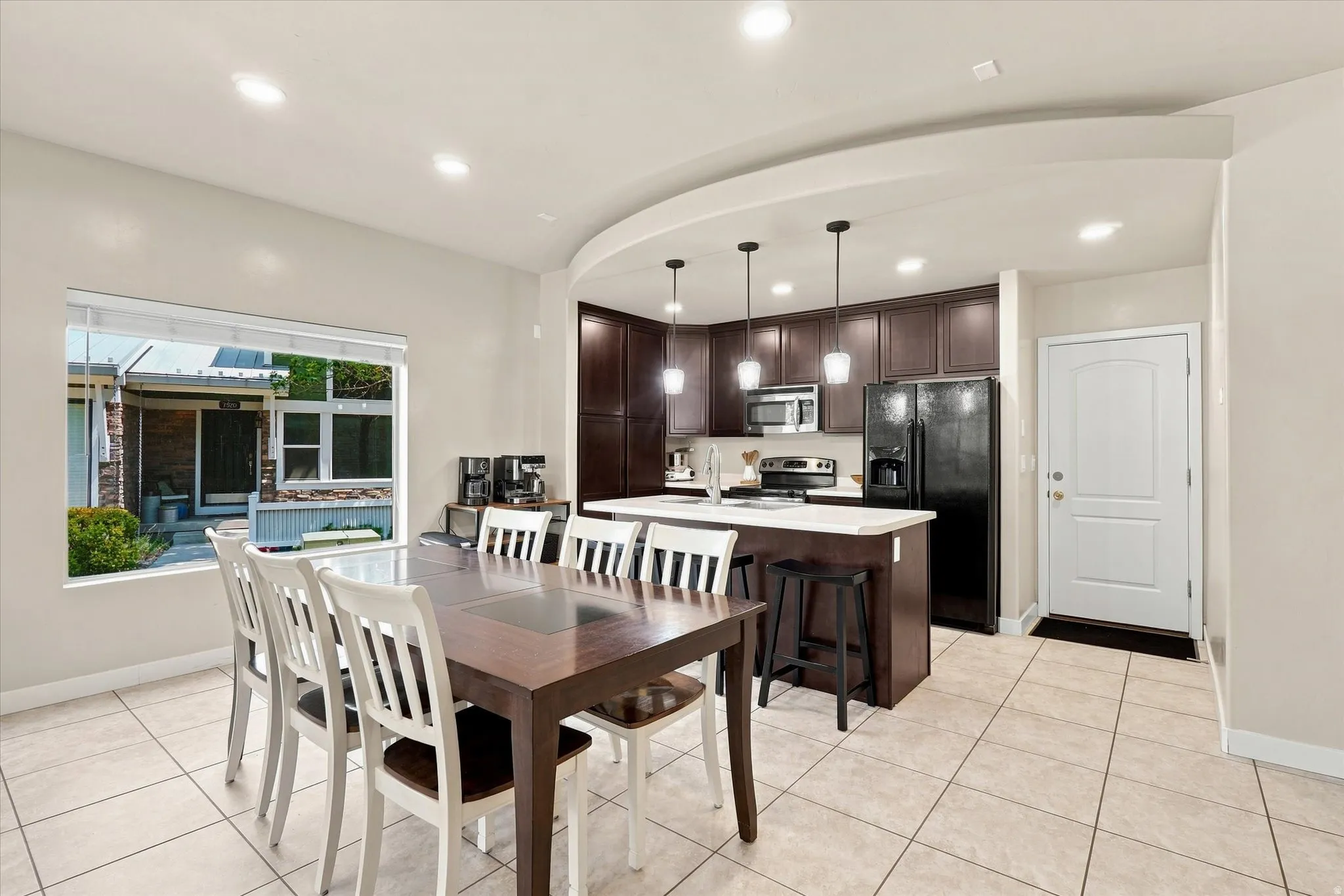 Open concept living space featuring tiled flooring and recessed lighting