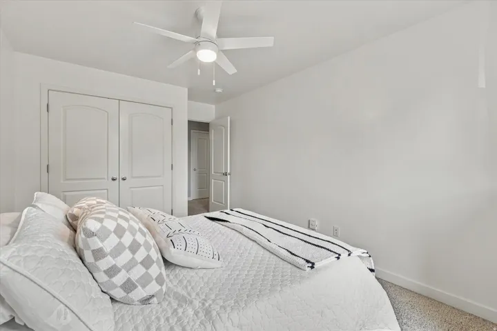 Recessed lighting, ceiling fan with integrated light, carpeted flooring, and white paneled doors