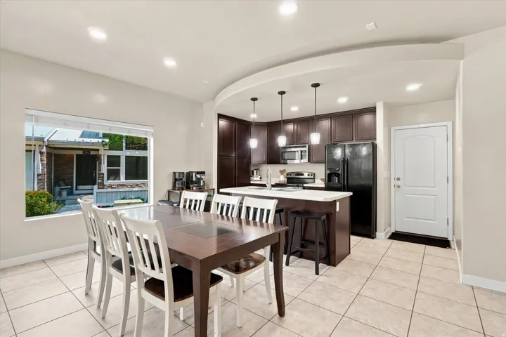 Open concept living space featuring tiled flooring and recessed lighting