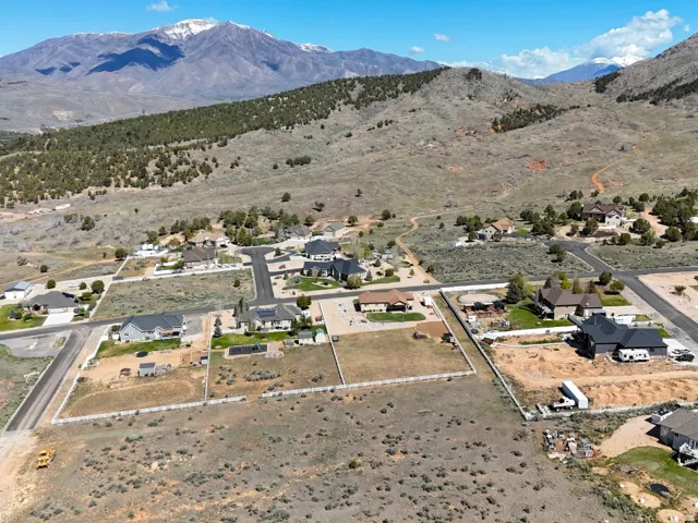 Expansive land parcel with surrounding residential development and mountain backdrop