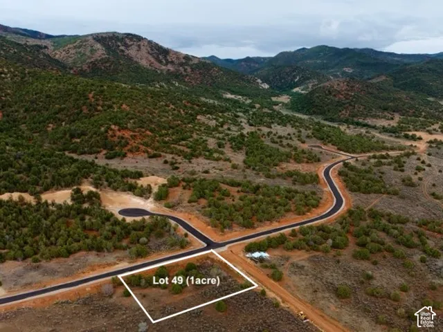 Paved road access, mountainous terrain, and natural landscaping