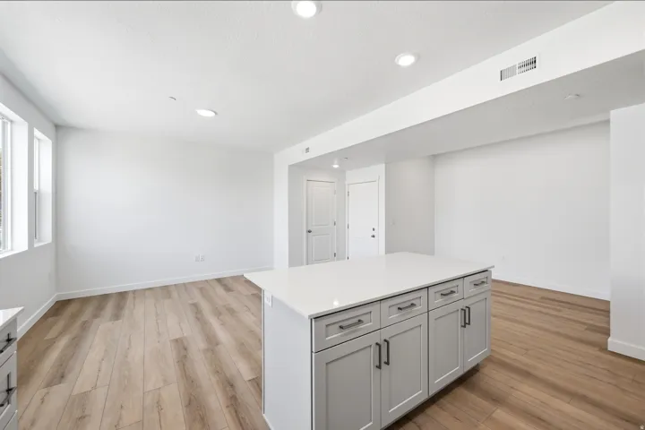 Central kitchen island with gray cabinetry and stone countertop