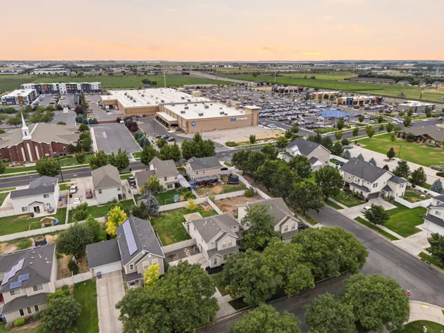 Residential neighborhood with established street trees, featuring a mix of single-family homes and multi-unit dwellings