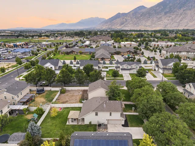 Residential neighborhood with established trees, paved streets, and mountain backdrop