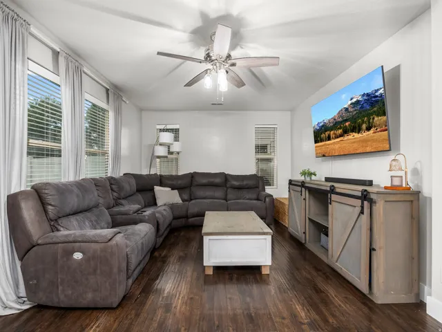 Dark wood-finish flooring complements the light wall color