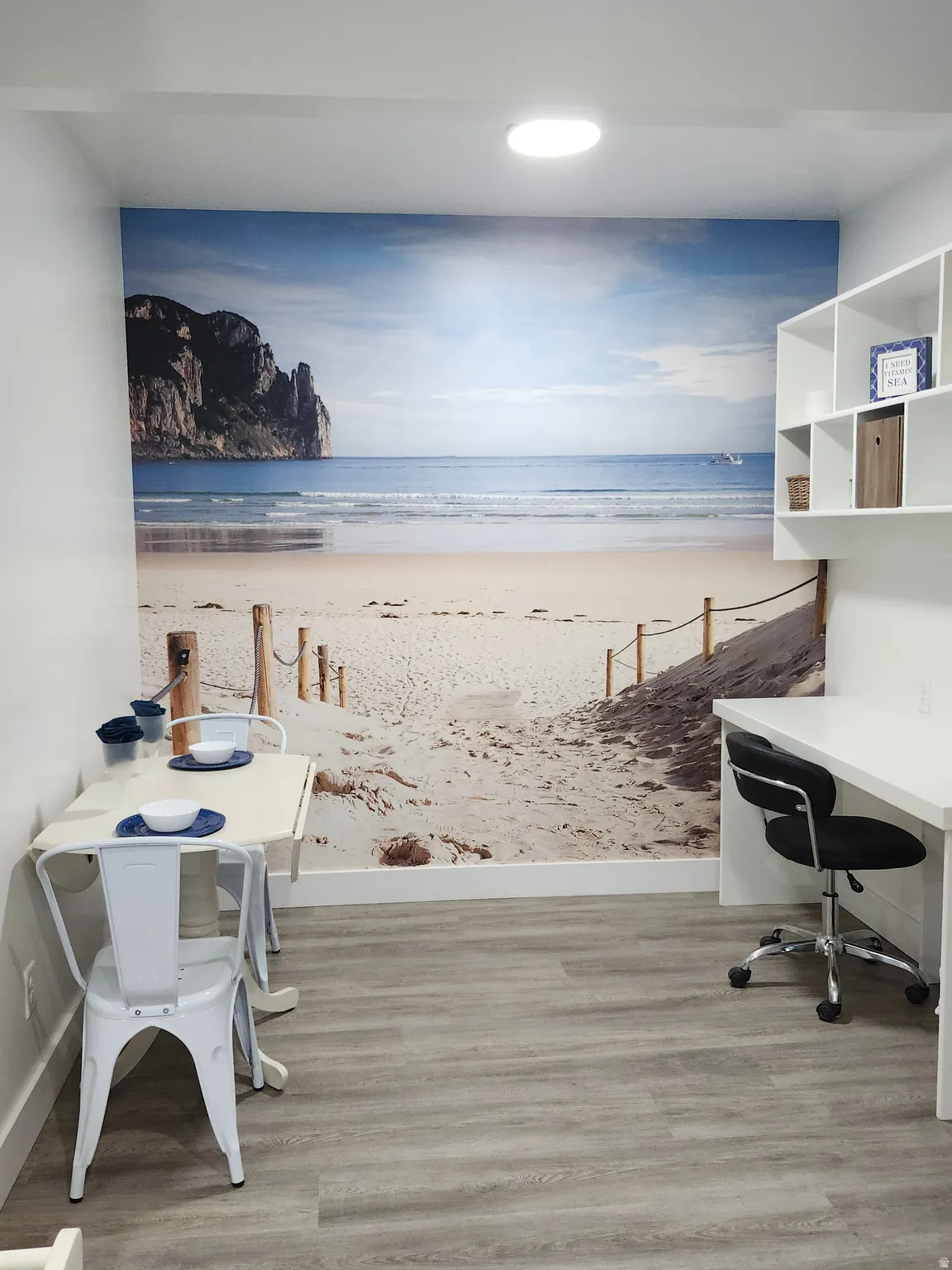 Wood-finish flooring, recessed lighting, built-in shelving, and a wall-mounted desk