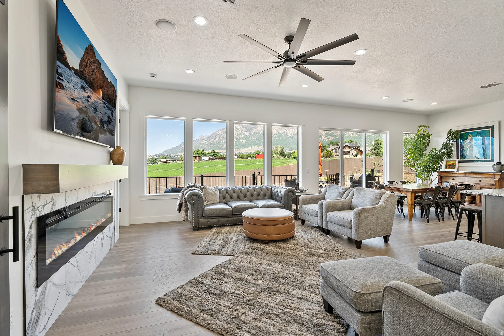 Living area featuring wood-finish flooring, recessed lighting, and a modern ceiling fan