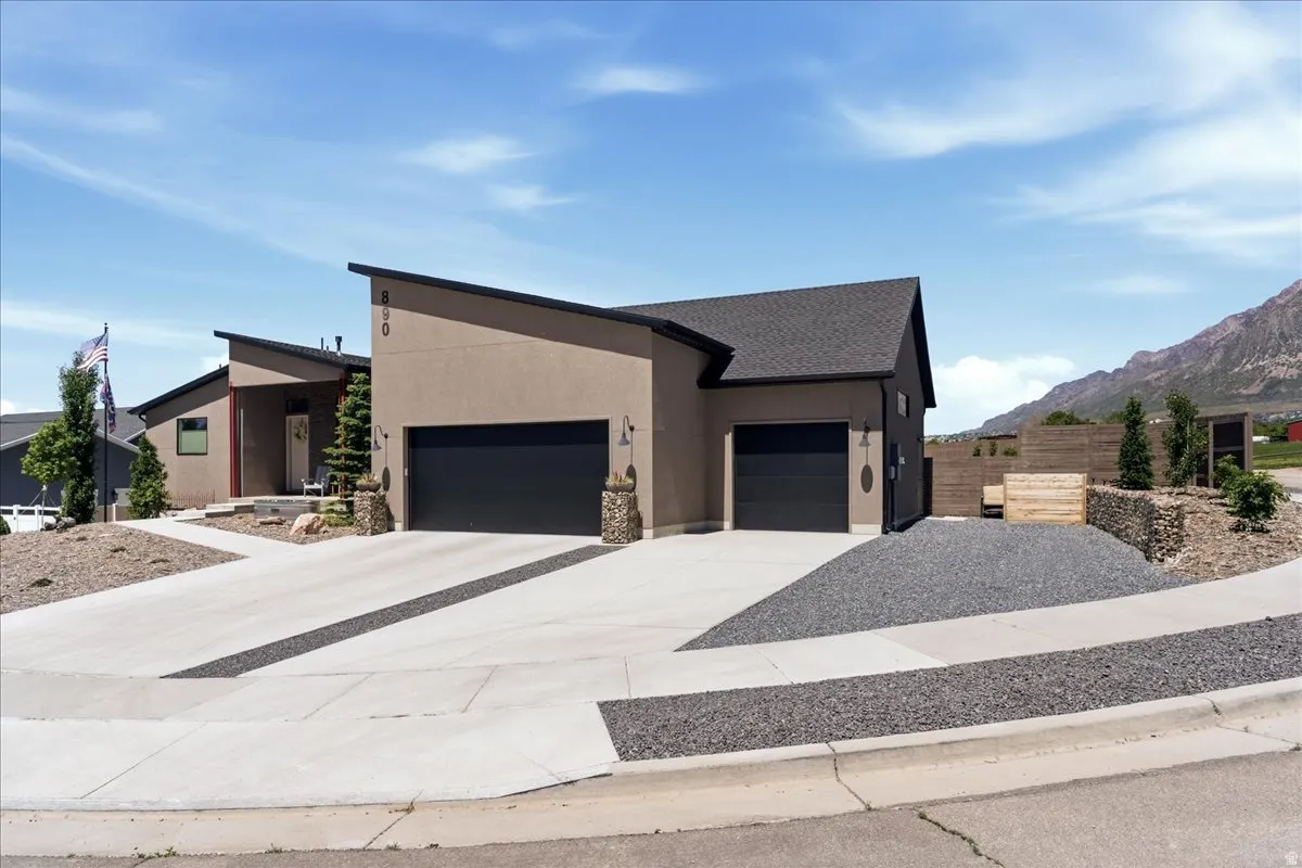 Contemporary architecture featuring a multi-pitched roofline and stucco exterior