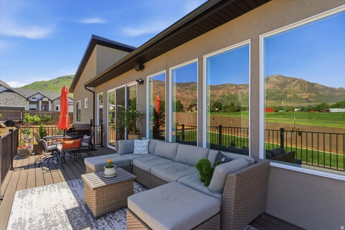Expansive outdoor deck featuring wood-look decking and black metal railings