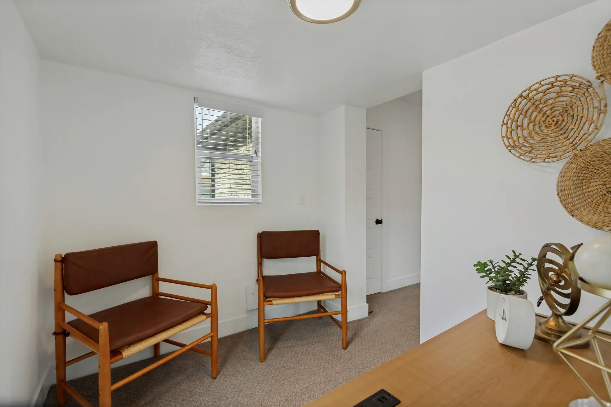 Recessed window with blinds, light-toned carpeting, and a flush-mount ceiling light fixture