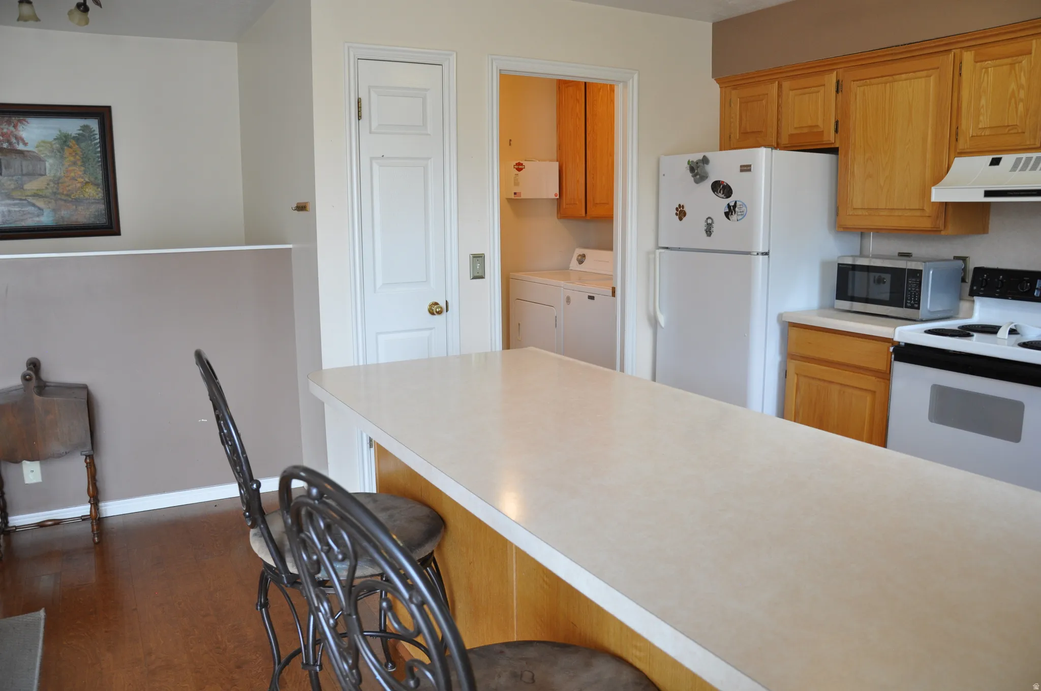 Kitchen featuring wood-finish cabinetry and a light-toned countertop