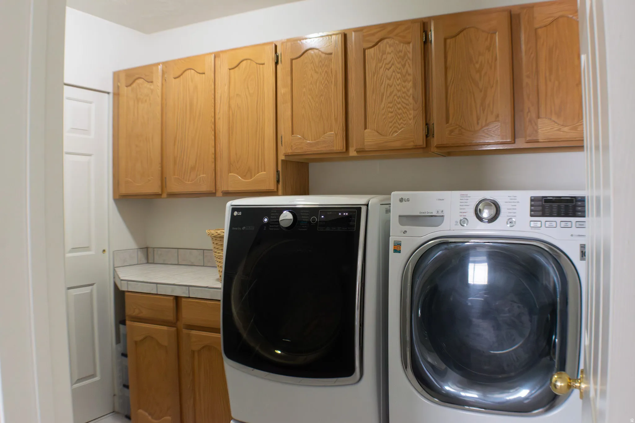 Upper and lower wood-finish cabinetry with a laminate countertop