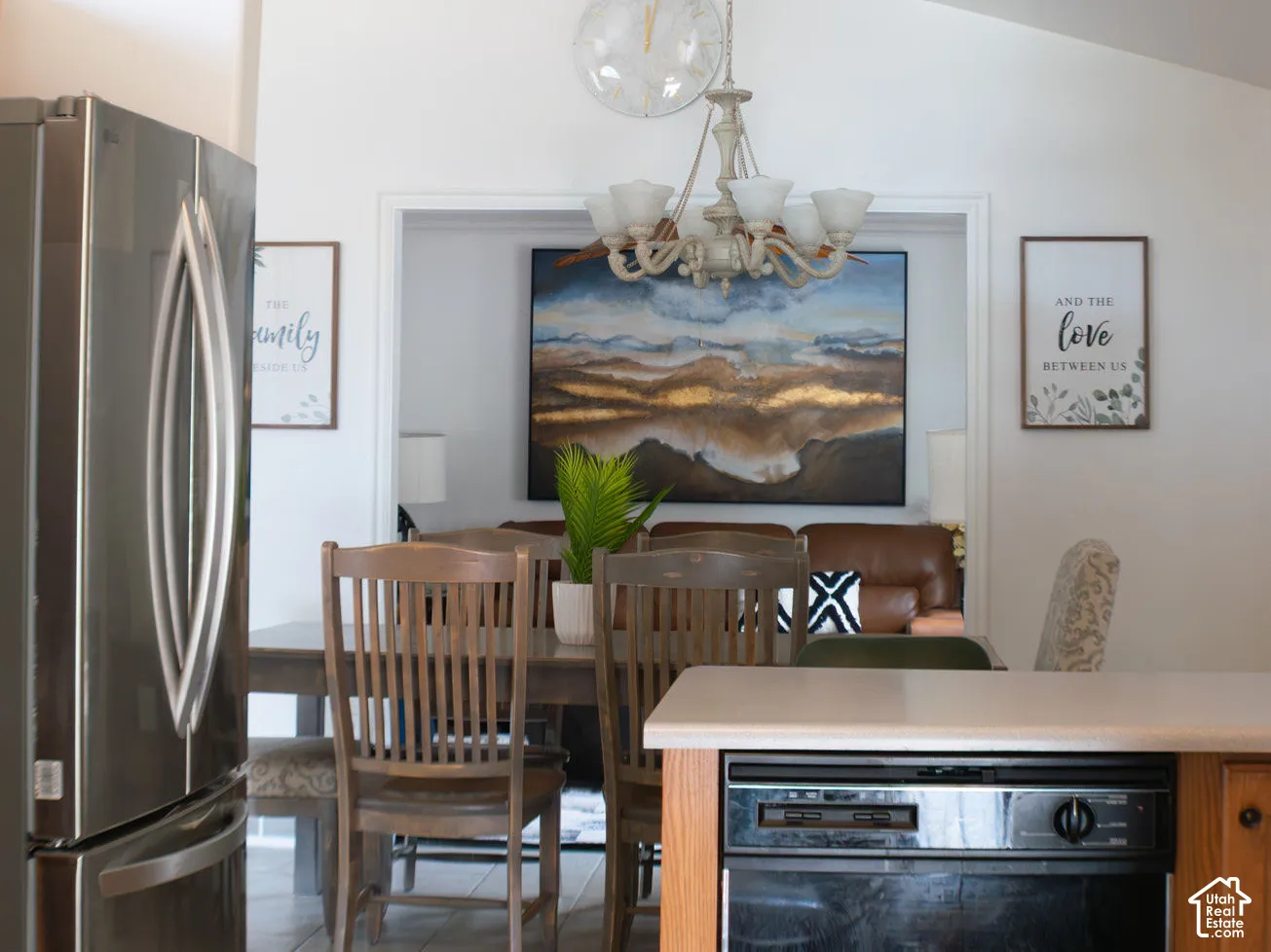 Vaulted ceiling, stainless steel refrigerator, tile flooring, light wood-finish cabinetry, built-in dishwasher