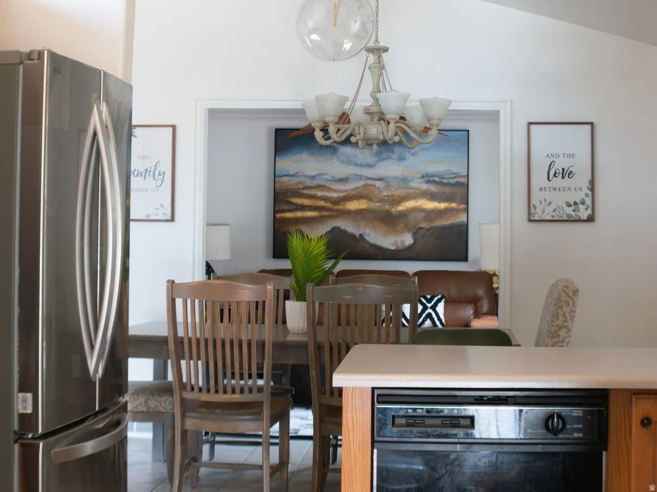Vaulted ceiling, stainless steel refrigerator, tile flooring, light wood-finish cabinetry, built-in dishwasher