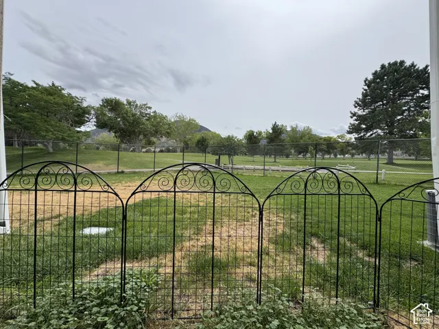 Decorative wrought iron fencing enclosing a grassy area