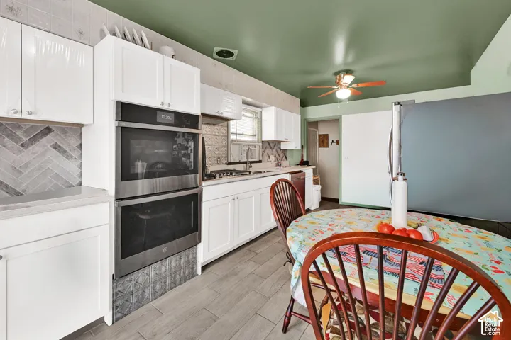 Double oven, quartz countertops, tile backsplash