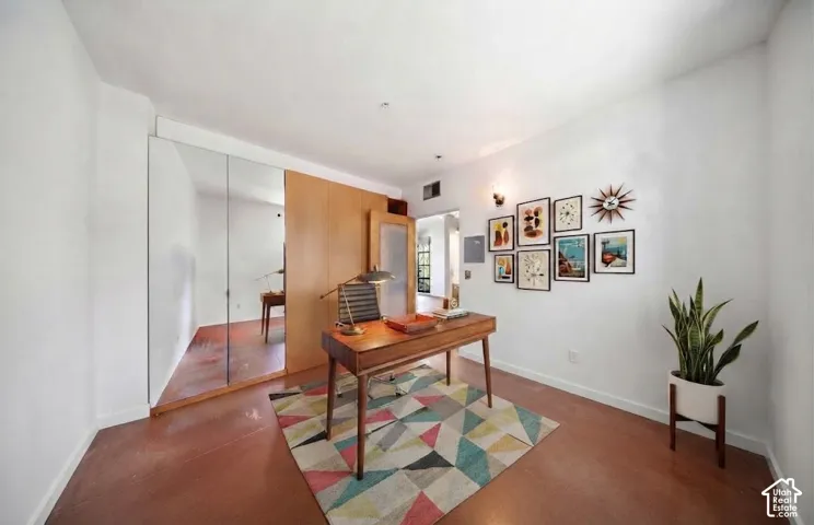 Wood-finish flooring with white walls and mirrored closet doors