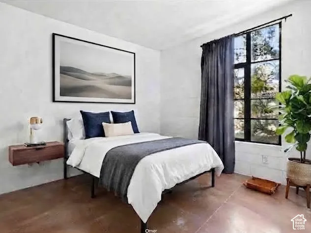 Textured white walls, angled window with black framing, wood-finish flooring, and a floating wood-tone nightstand