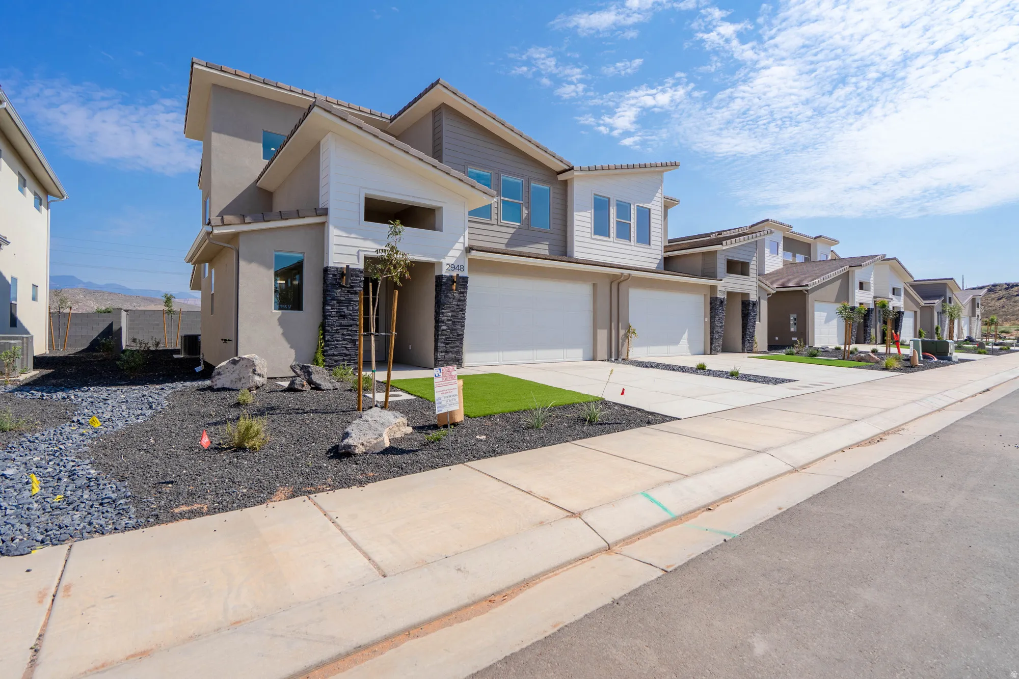 Contemporary exterior featuring stucco, horizontal siding, and stone accents