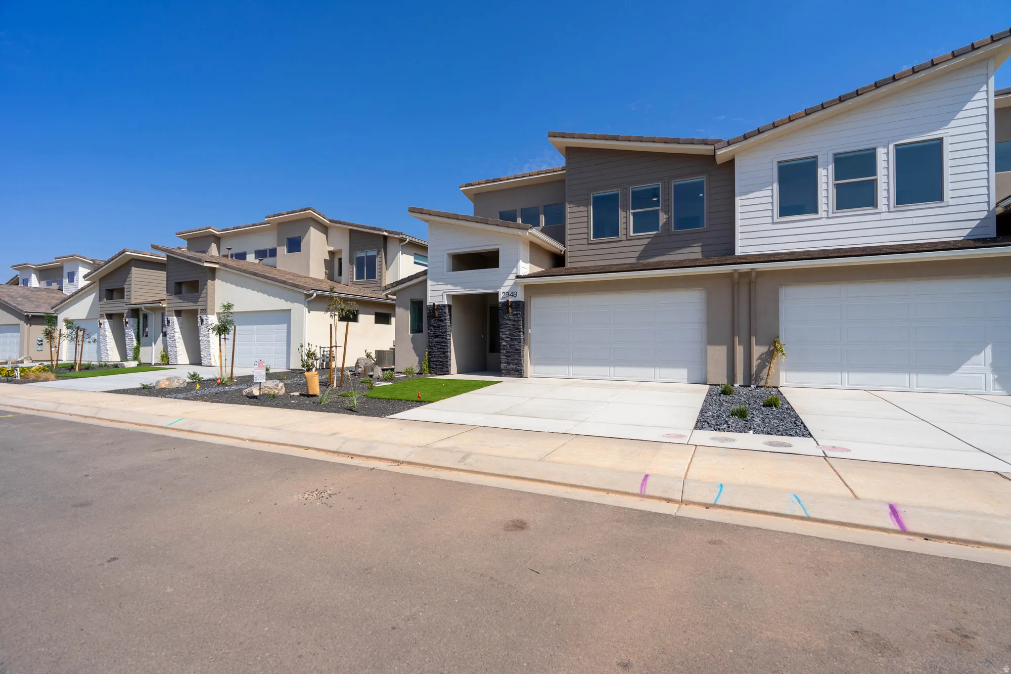Contemporary architectural style featuring multi-tone siding and stone accents