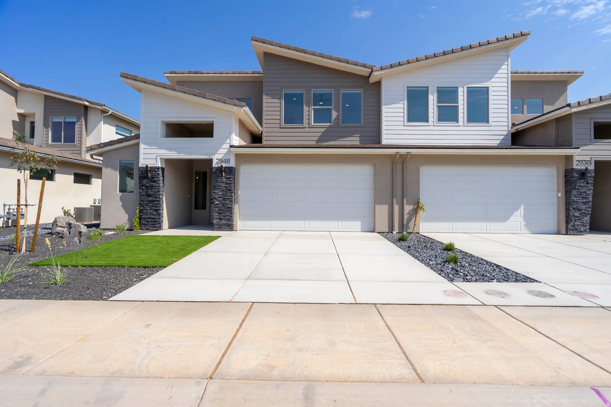 Modern multi-story exterior with an asymmetrical roofline