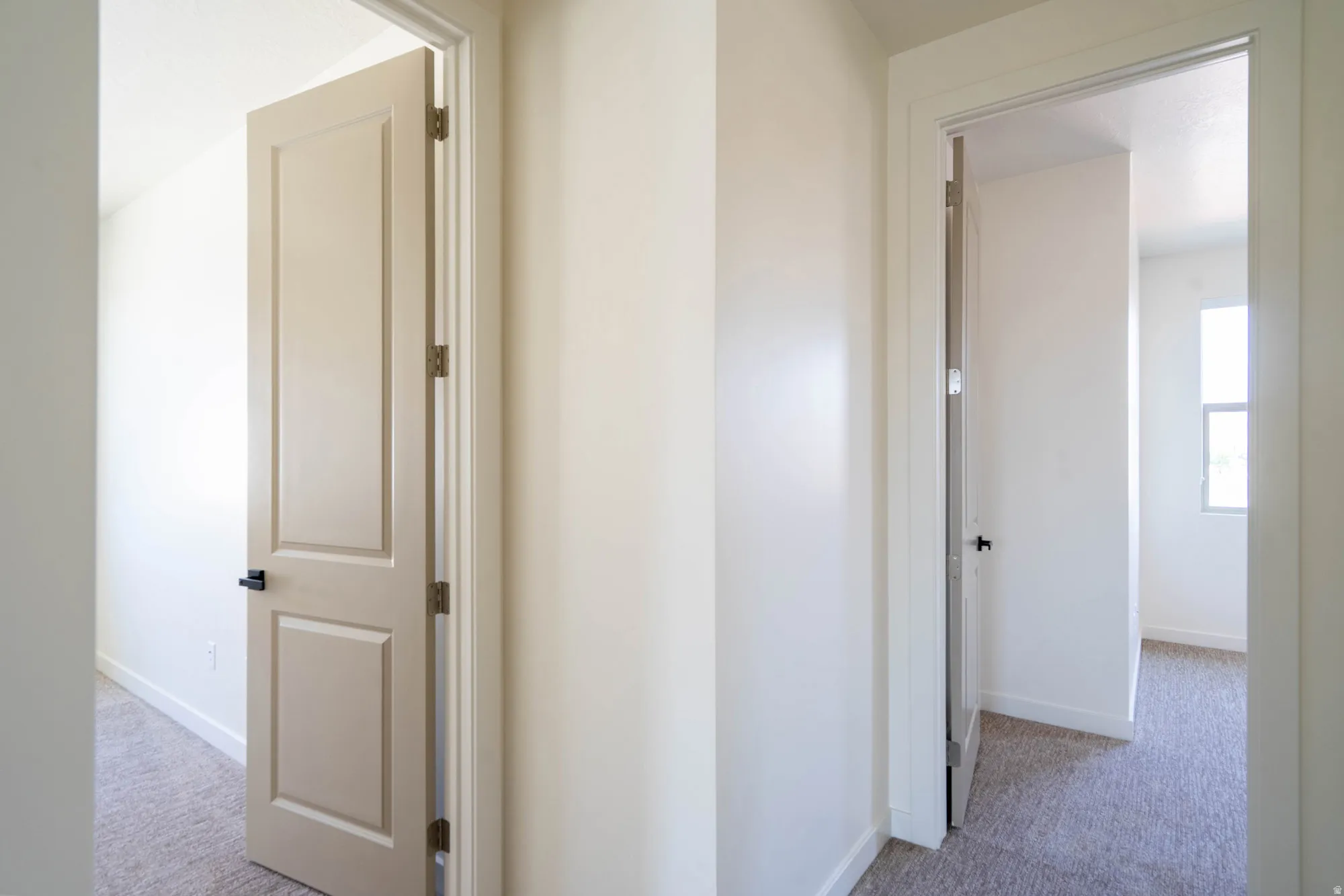 Neutral wall colors, white trim, and light carpeting throughout
