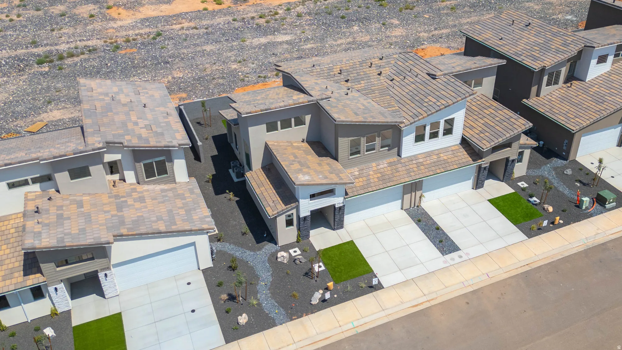 Contemporary two-story residence featuring a multi-textured exterior, multi-panel windows, and an integrated two-car garage