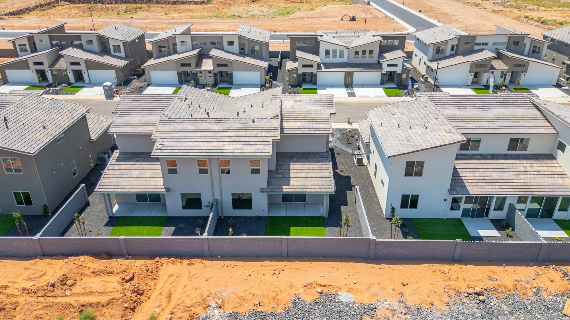 Rear exterior featuring a patio, artificial turf, and privacy fencing
