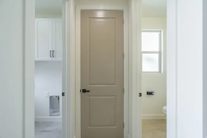 White shaker-style upper cabinetry with dark hardware