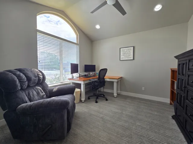 Arch-top window with blinds, vaulted ceiling, recessed lighting, and a ceiling fan