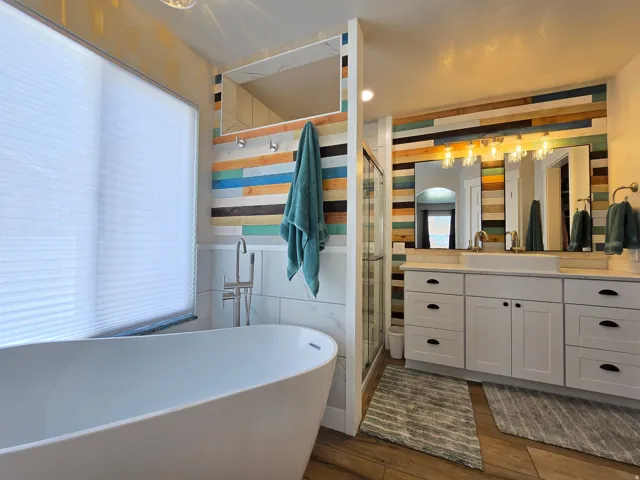 Freestanding soaking tub with floor-mounted faucet