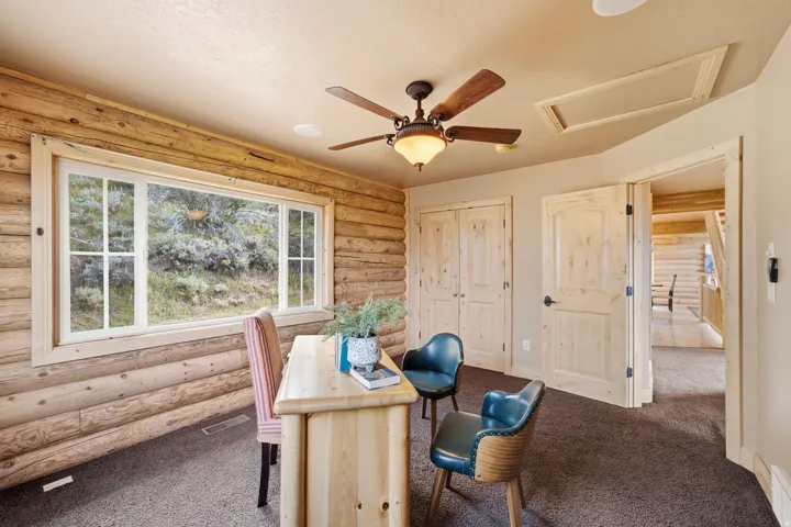Log wall construction featuring a white-framed window