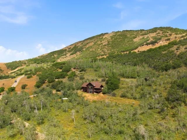 Hillside property featuring a multi-story residence with a brown exterior and multiple balconies