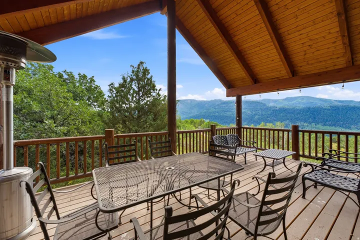 Expansive outdoor deck featuring a wood-plank floor and natural wood railing