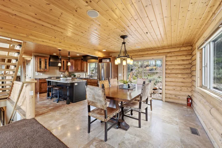 Wood-paneled ceilings, log wall construction, and tiled flooring