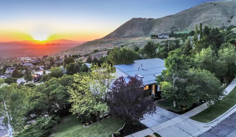 Contemporary residence with a metal roof, an attached two-car garage, and a concrete driveway