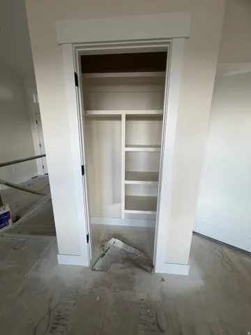 Built-in closet shelving, integrated hanging rod, and trim details