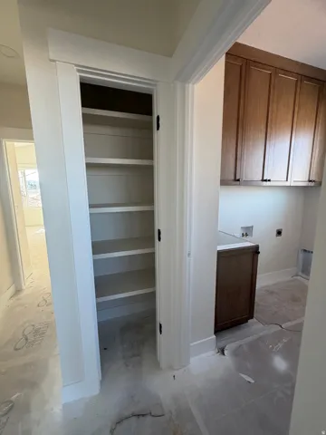 Built-in shelving, wood-finish cabinetry, and white trim details