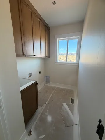 Built-in cabinetry, single window, and a lower cabinet