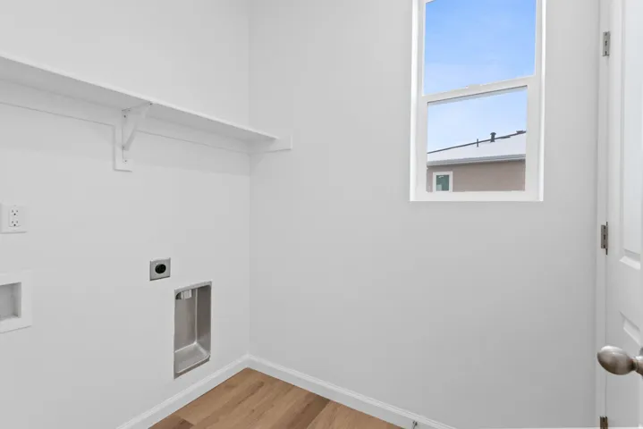 Built-in shelving, wood-finish flooring, and a single window