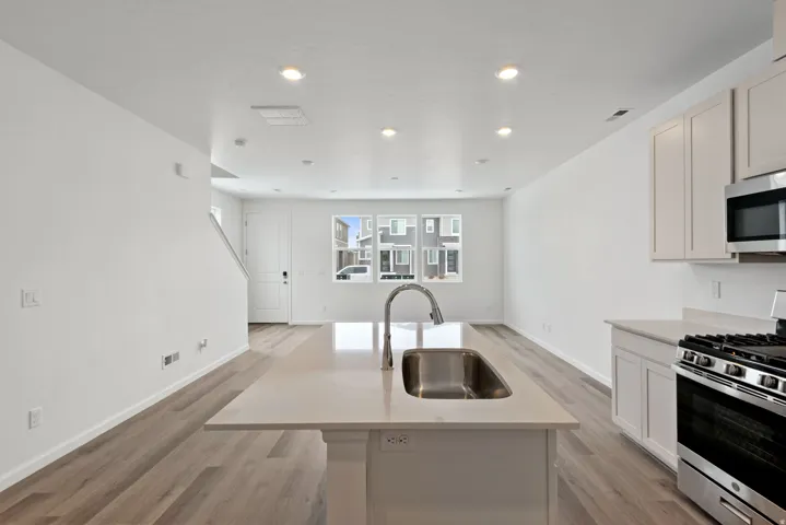 Kitchen island with an undermount sink and a gooseneck faucet
